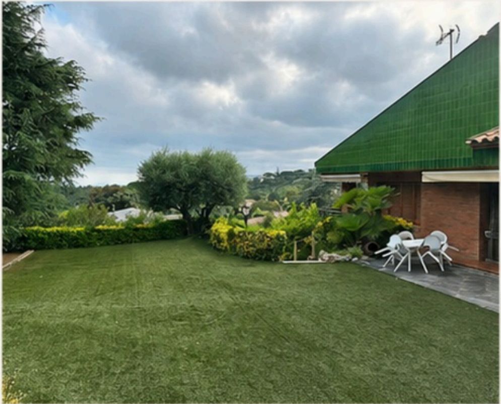 Lawn garden beside the house with outdoor seating