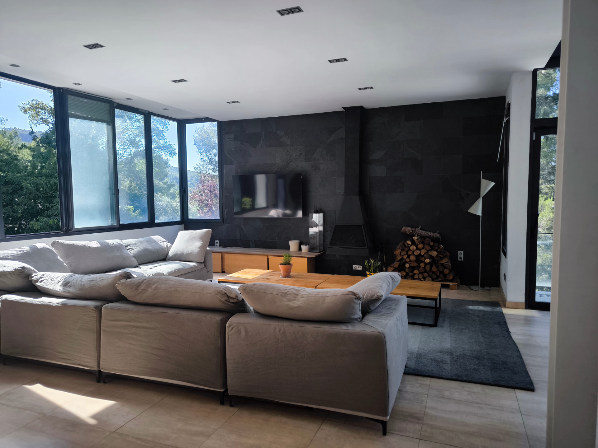 Living room with slate wall, fireplace and corner windows